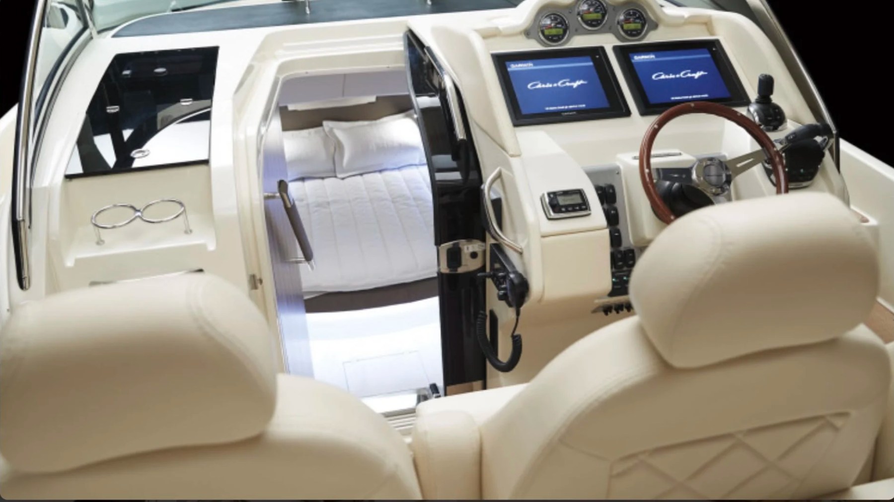 Premium helm and cabin entrance aboard a 38' Chris-Craft Boat Rental in Riviera Beach featuring dual Garmin displays.