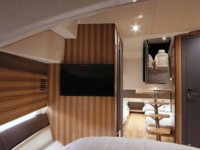 38' Chris-Craft Boat Rental cabin featuring a modern stateroom with premium wood finishes, flat-screen TV and elegant interior in Riviera Beach.