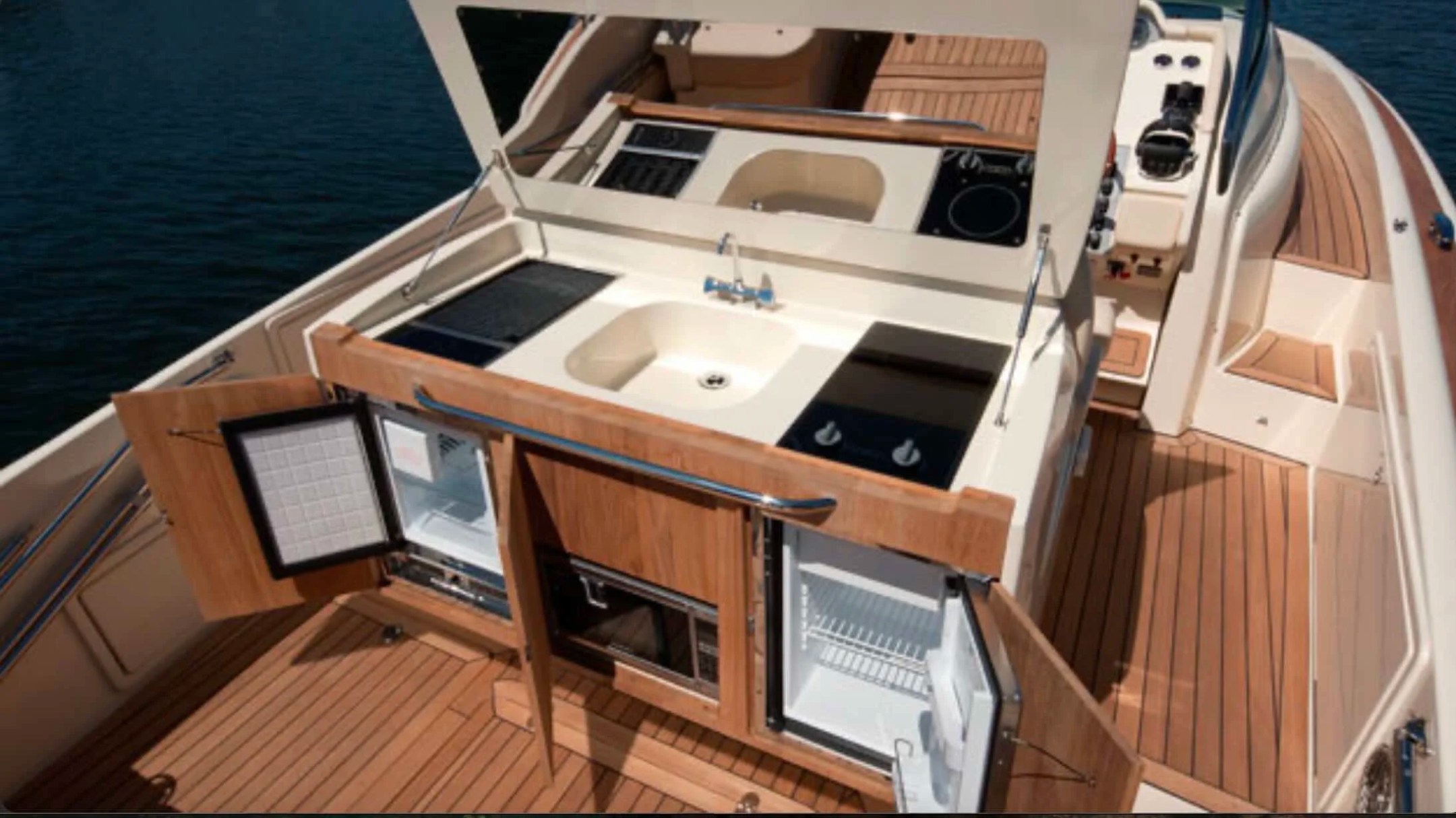 38' Chris-Craft Boat Rental featuring a premium outdoor galley with sink, grill, refrigerator and entertainment station in Riviera Beach.