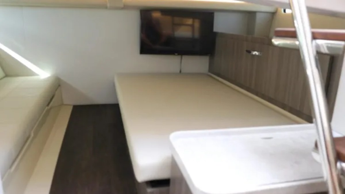 38' Regal Boat Rental lower cabin sleeping area with TV in Riviera Beach Florida.