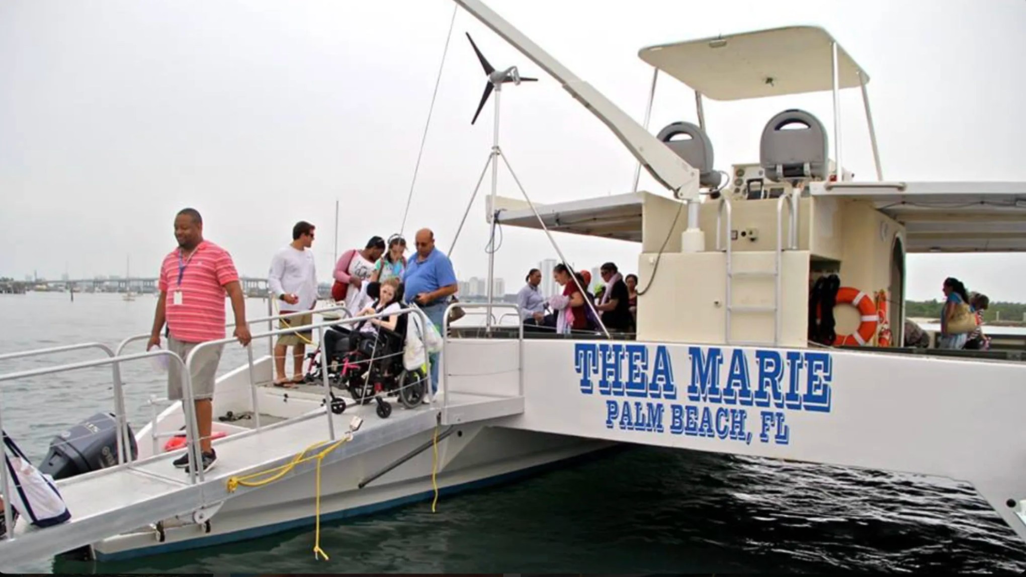 ADA-accessible boarding ramp leading onto a 49' PowerCat Boat Rental in Riviera Beach Florida.