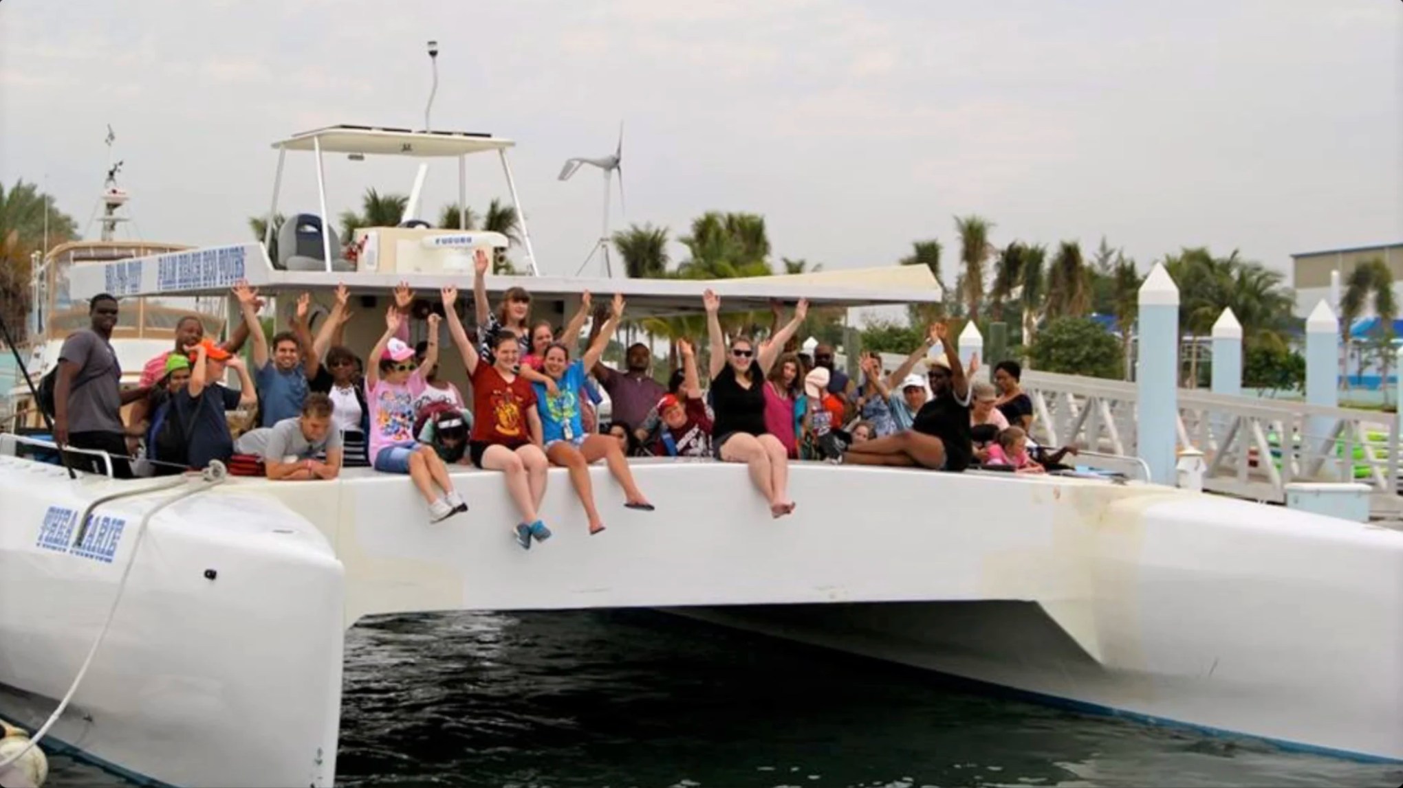 Guests celebrating aboard a 49' PowerCat Boat Rental docked in Riviera Beach before a private charter adventure.