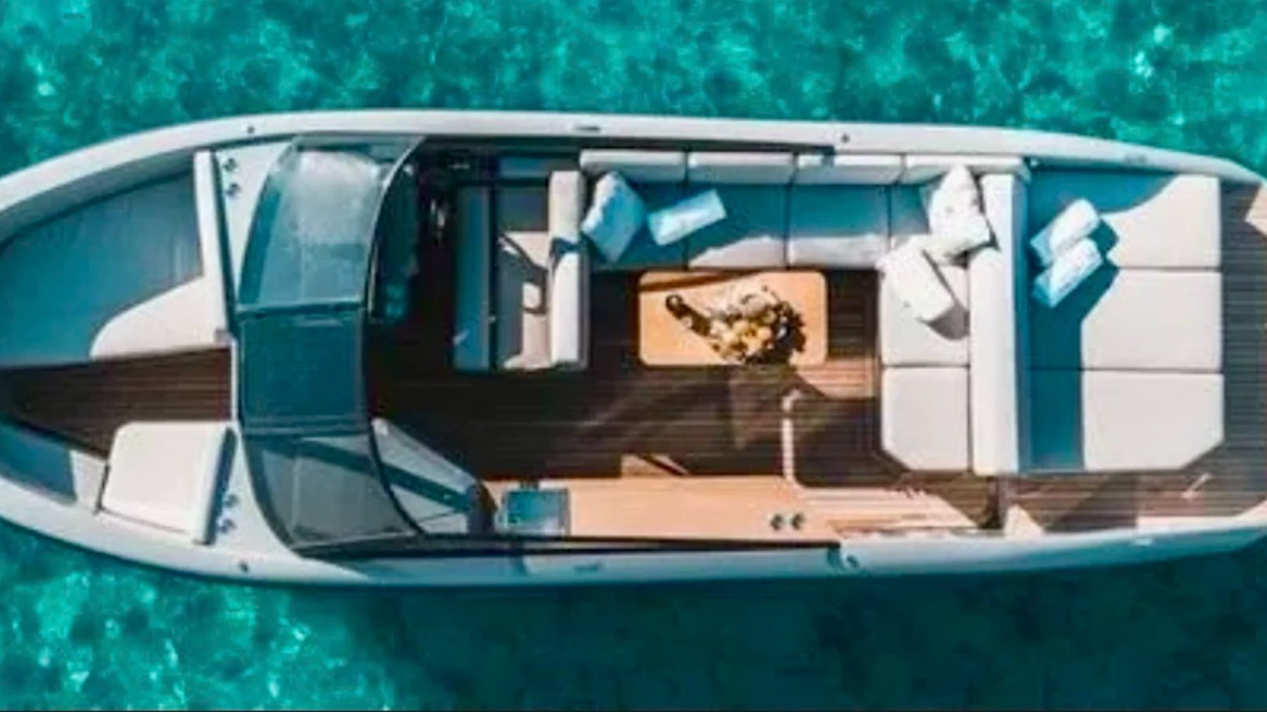 Aerial view of the spacious open deck and lounge seating aboard a 29' RAND Boat Rental in Riviera Beach, Florida.