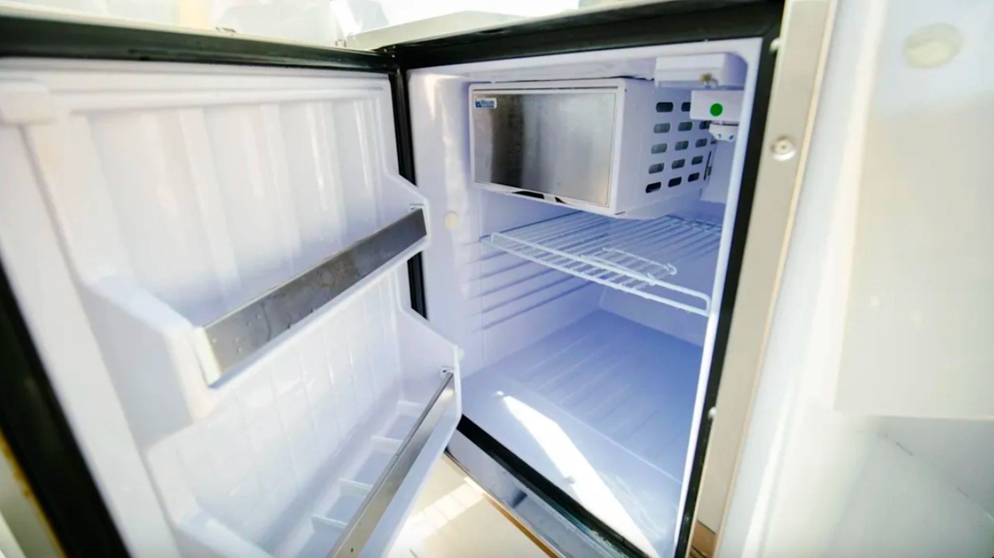 Built-in refrigerator aboard a 29' RAND Boat Rental in Riviera Beach, Florida for keeping drinks and refreshments chilled.