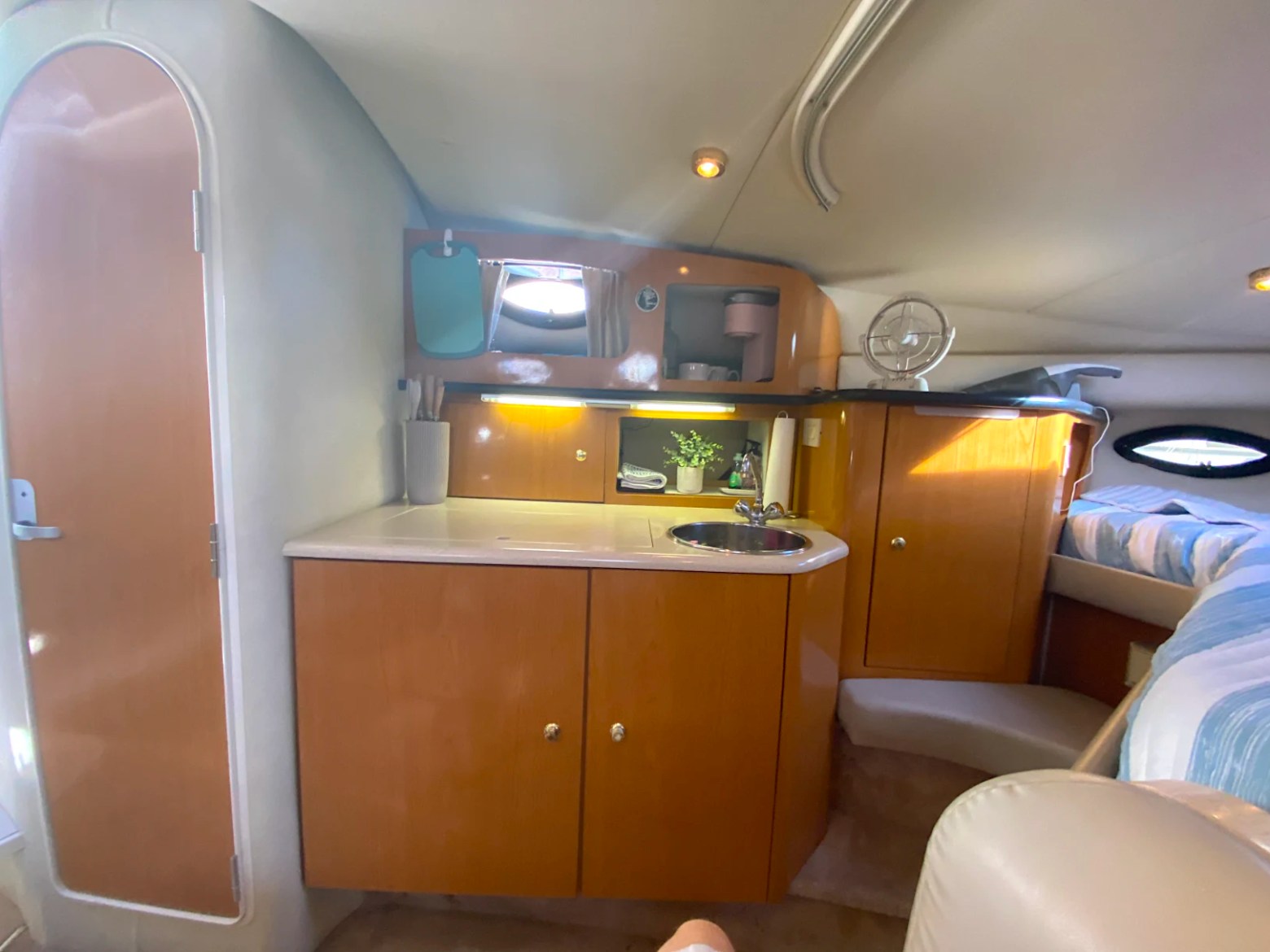 33' Regal Boat Rental cabin with galley, sink, wood cabinetry and sleeping area in Jacksonville, Florida.