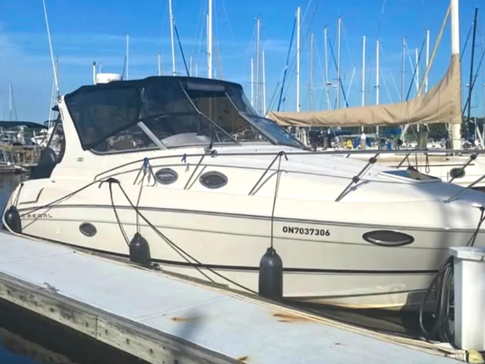 33' Regal Boat Rental docked at a marina with covered cockpit and express cruiser profile in Jacksonville, Florida.