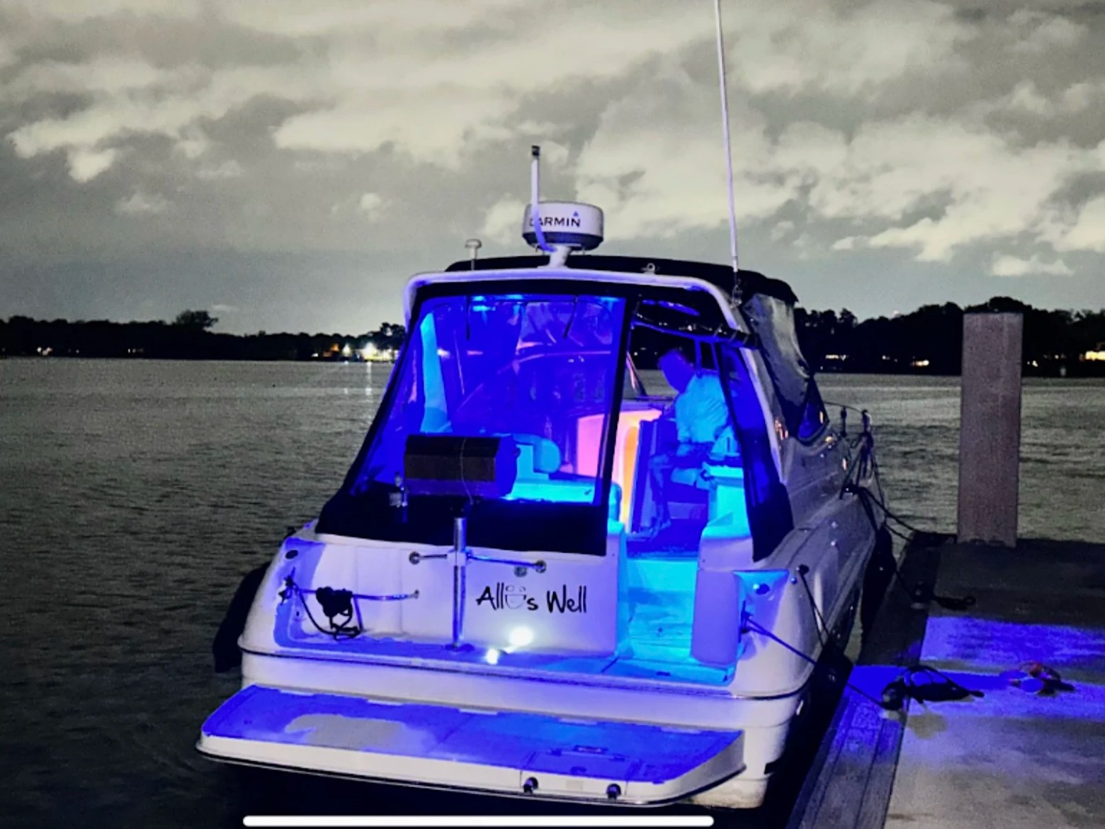 33' Regal Boat Rental illuminated with blue cockpit lighting at night on the waterfront in Jacksonville, Florida.