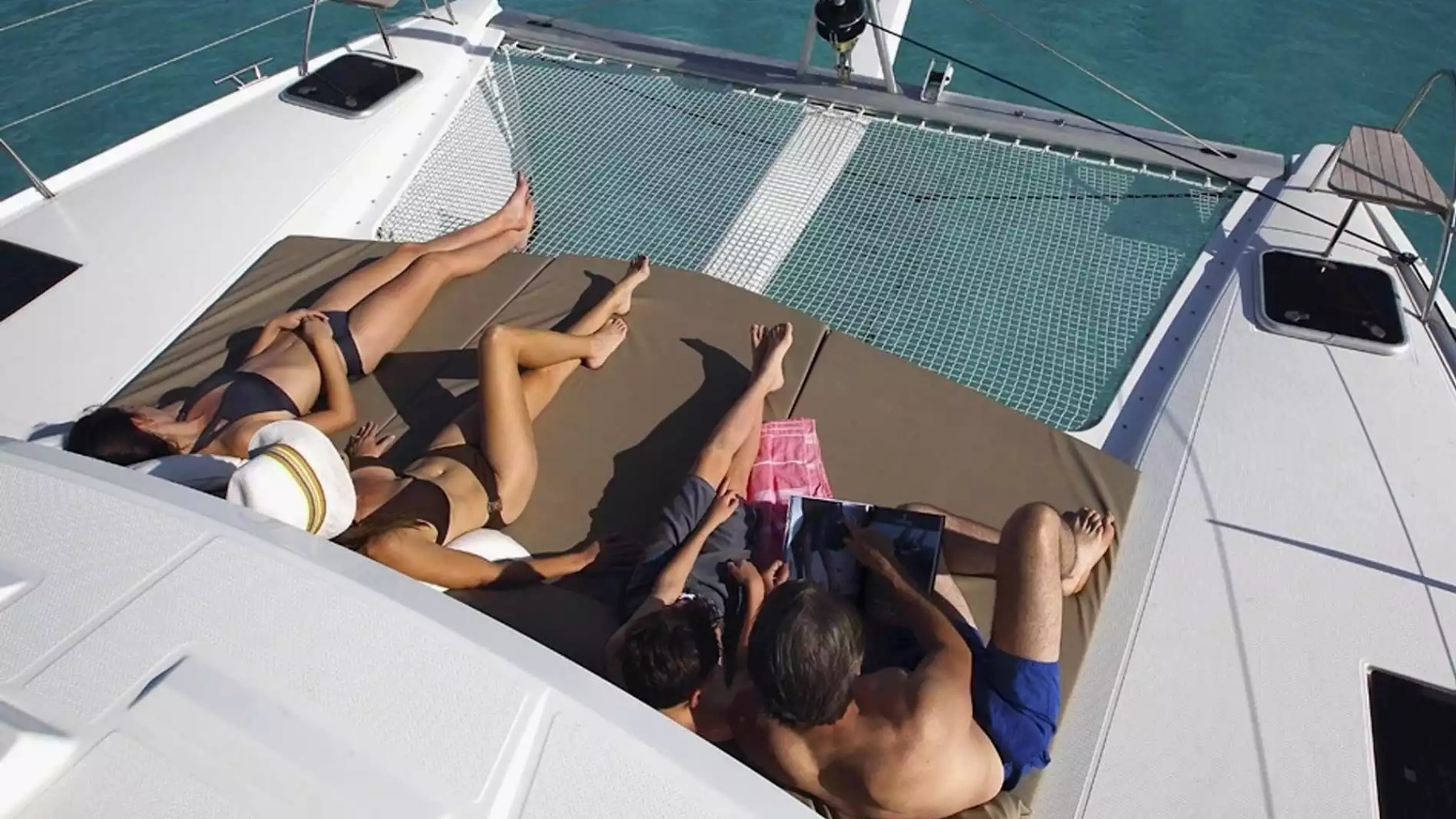 40' Fountaine Pajot Boat Rental with guests relaxing on the spacious bow lounge and trampoline.
