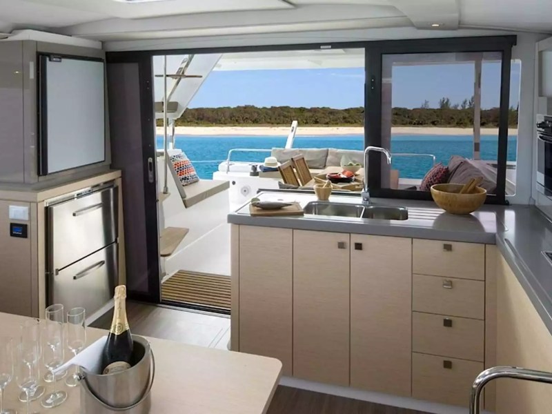 40' Fountaine Pajot Boat Rental with full galley, dining area and open access to the aft deck and tropical waters.