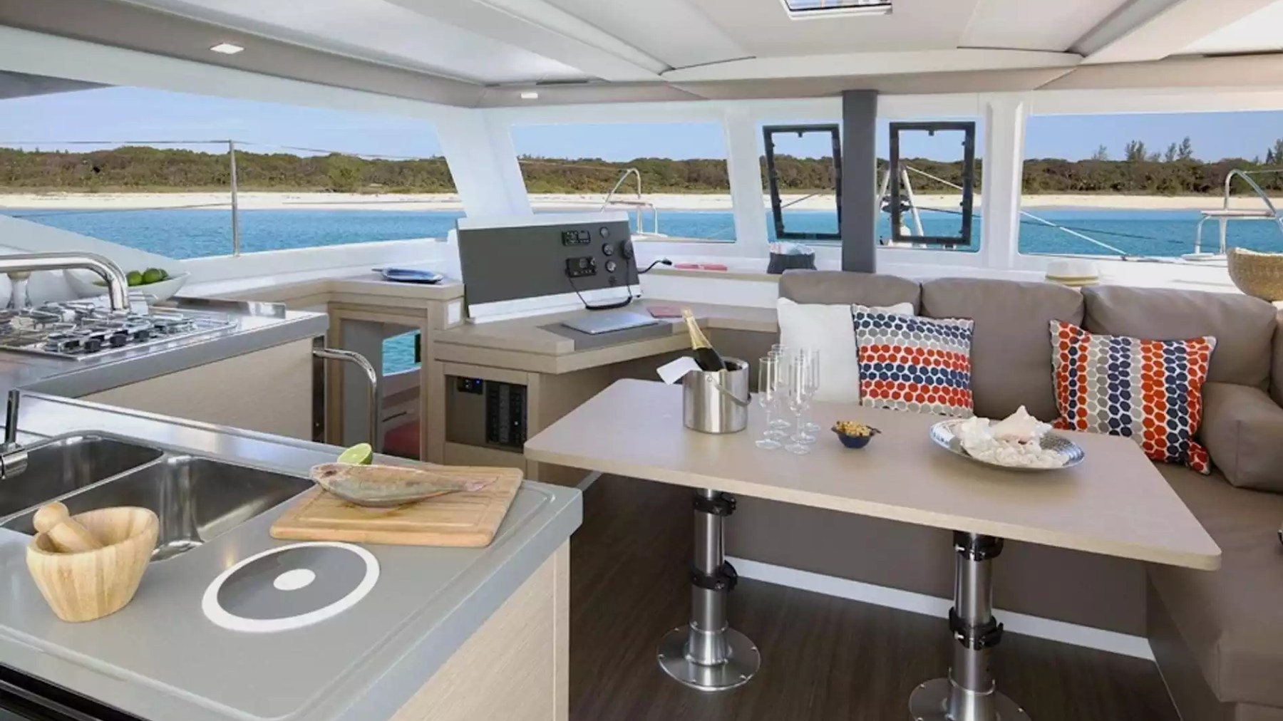 40' Fountaine Pajot Boat Rental with spacious salon, full galley and dining area overlooking tropical waters.