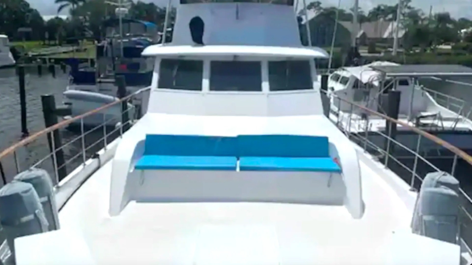 Spacious bow deck with turquoise lounge seating aboard a 53' Hatteras Yacht Charter in Key West, Florida.