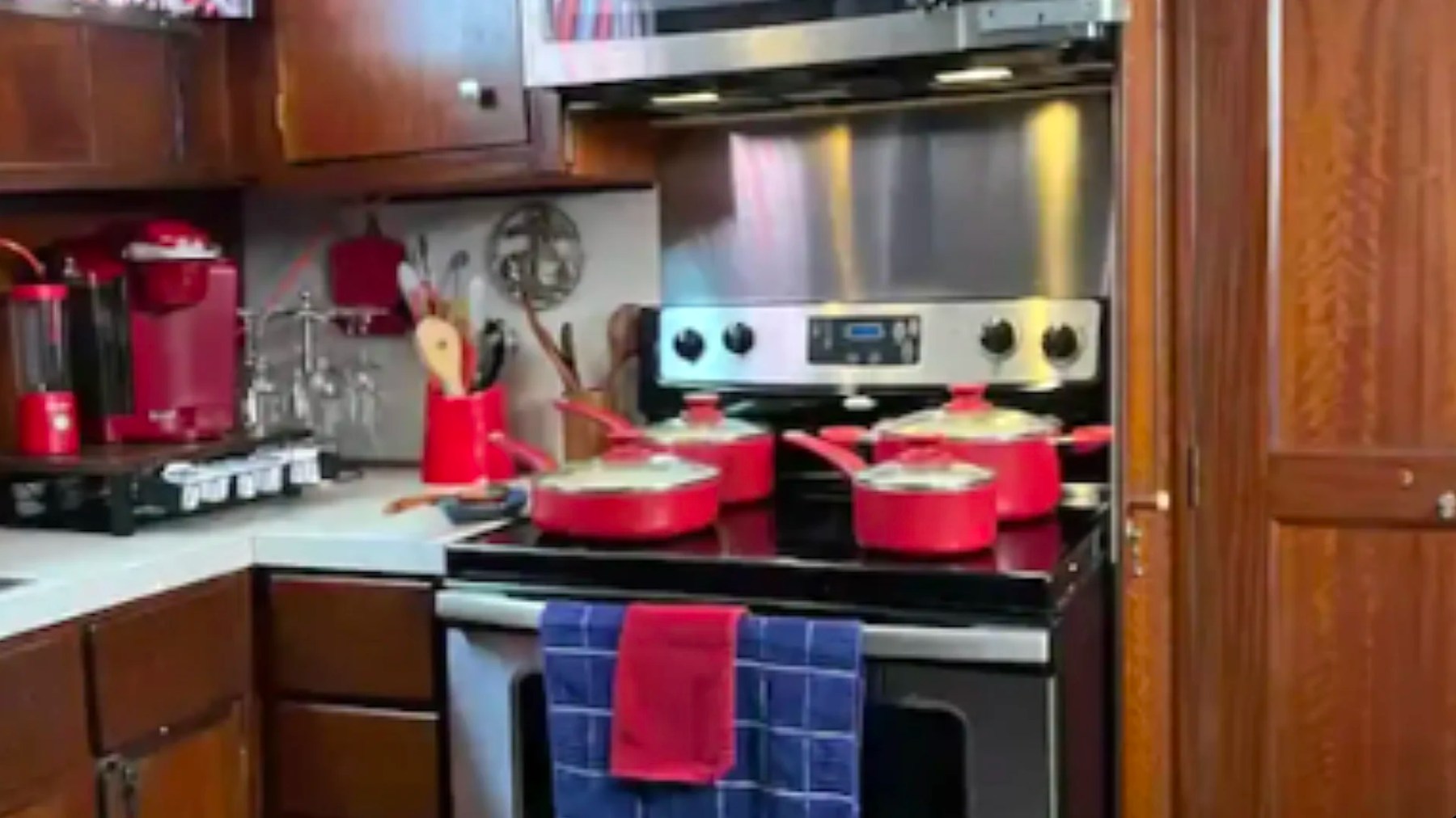 Full galley with stove, oven and wood cabinetry aboard a 53' Hatteras Yacht Charter in Key West, Florida.
