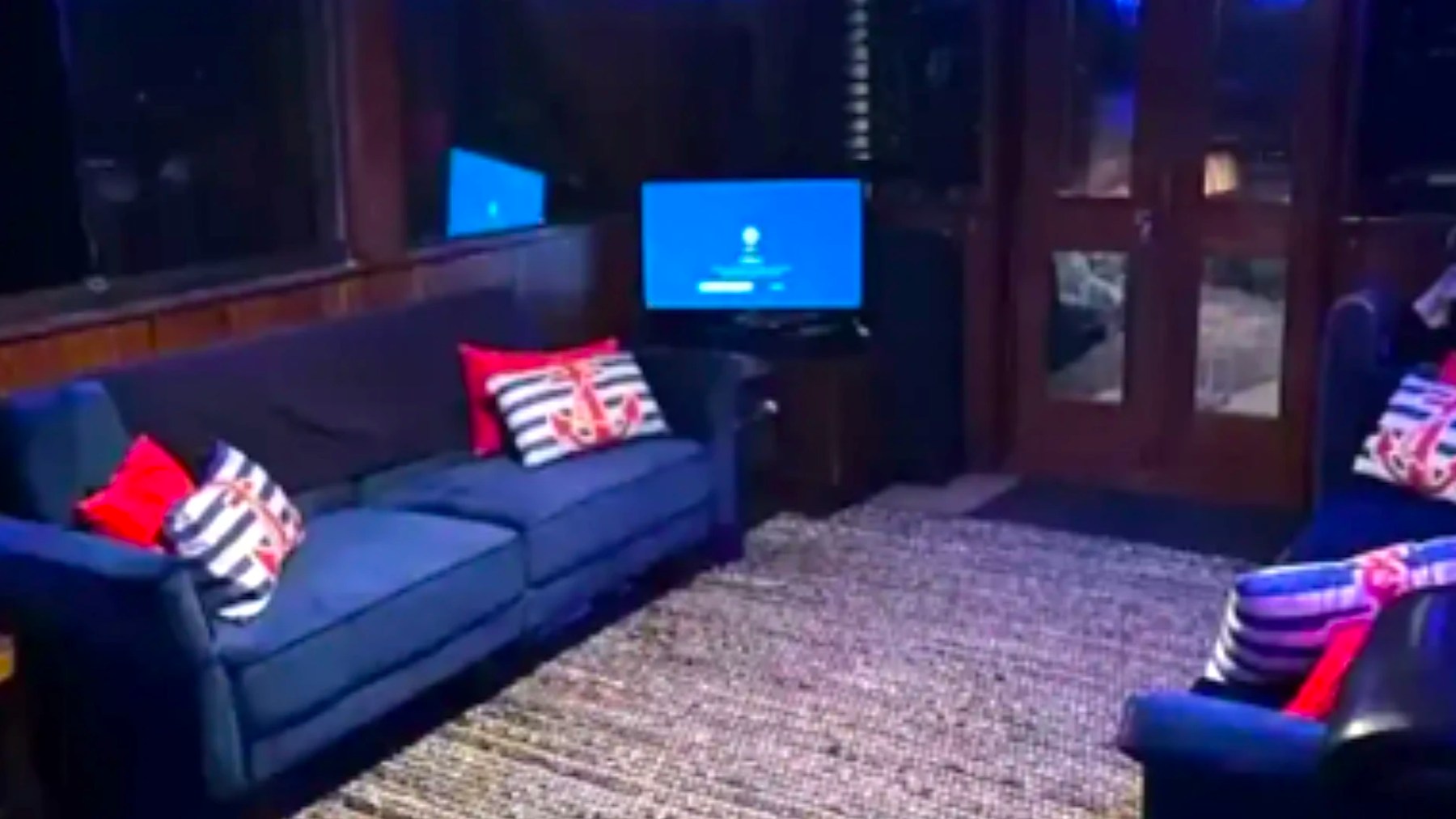 Comfortable salon with lounge seating and TV aboard a 53' Hatteras Yacht Charter in Key West, Florida.