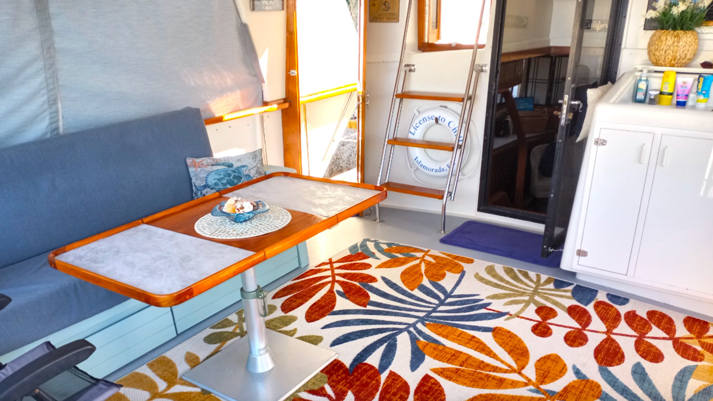 55' Californian Yacht Charter with covered aft deck lounge and dining table in Key Largo, Florida.