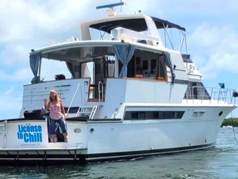 55' Californian Yacht Charter anchored in tropical waters with spacious aft deck and flybridge in Key Largo, Florida.