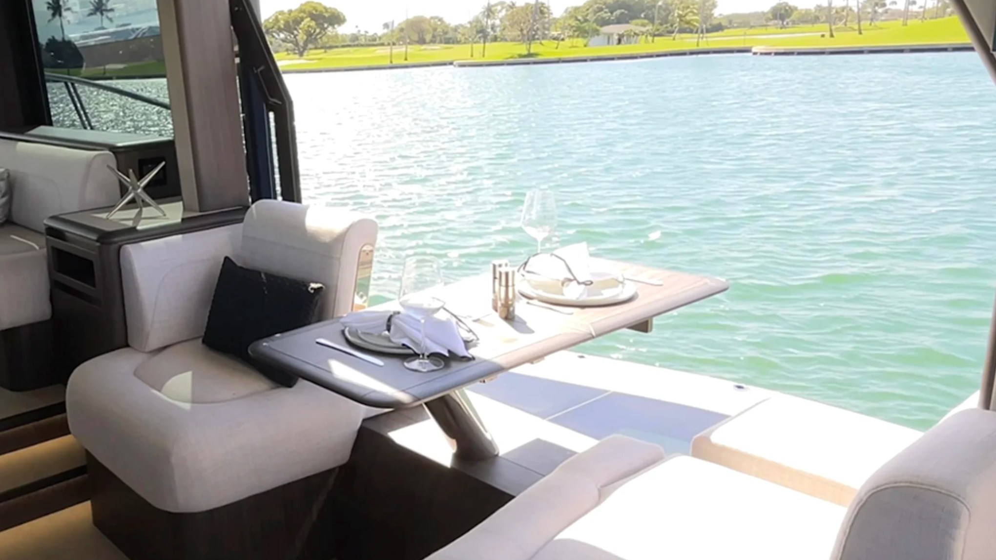 58' Galeon Yacht Charter with waterfront dining table and open side terrace in Fort Myers, Florida.