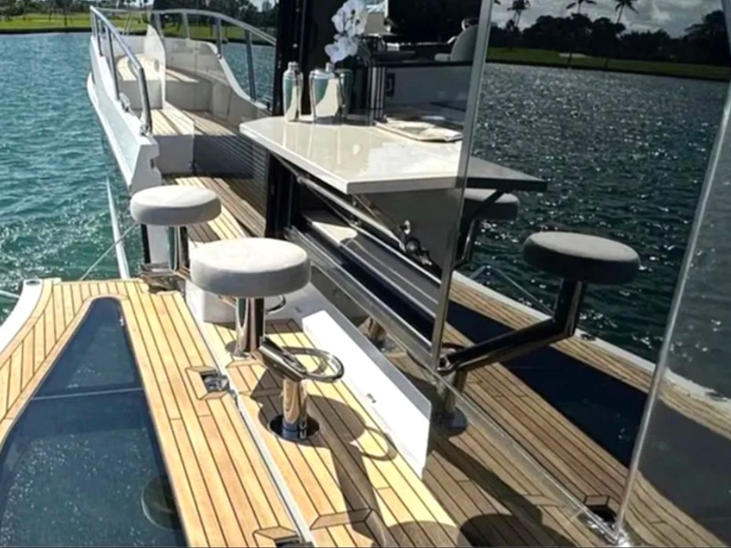 58' Galeon Yacht Charter with fold-out side terrace, bar seating and waterfront counter in Fort Myers, Florida.