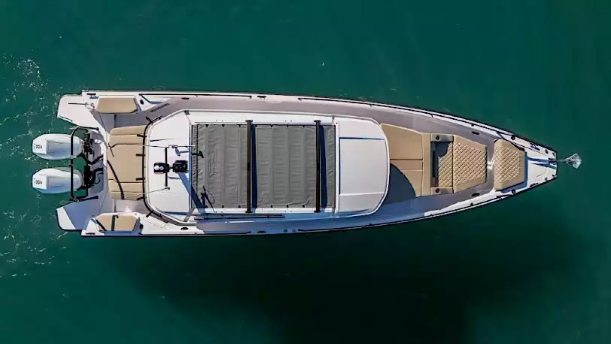Aerial view of an Axopar cabin boat with bow lounge seating and twin outboard engines in Key West, Florida.