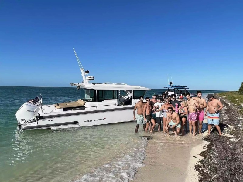 Axopar Boat Rental with a group of guests enjoying a tropical beach and sandbar stop.