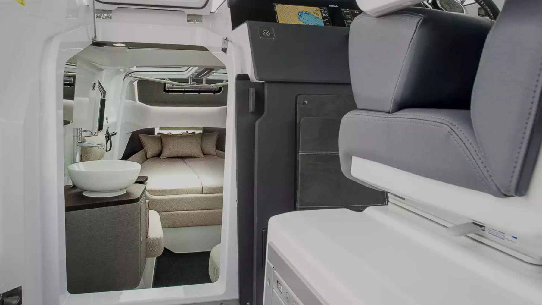 Axopar Boat Rental interior with private cabin, cushioned berth and modern washbasin below the helm.