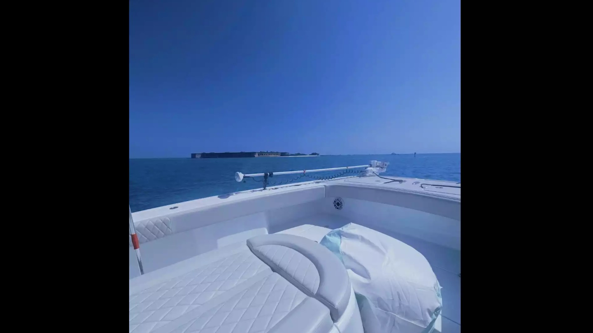 Center console fishing boat with spacious bow lounge seating and open-water views during a private boating trip.