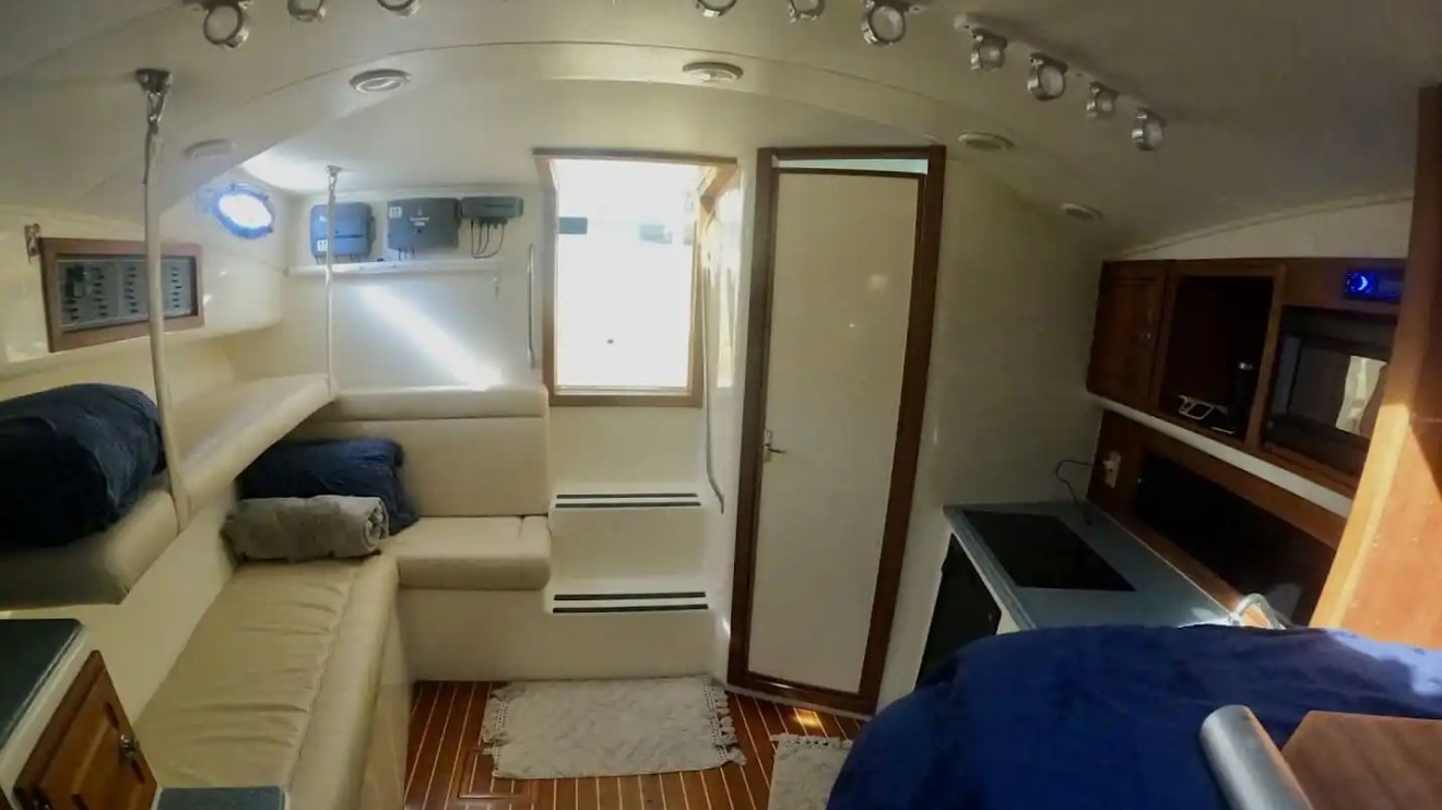 Key West Sportfishing Boat Rental cabin with wraparound seating, galley and wood flooring.