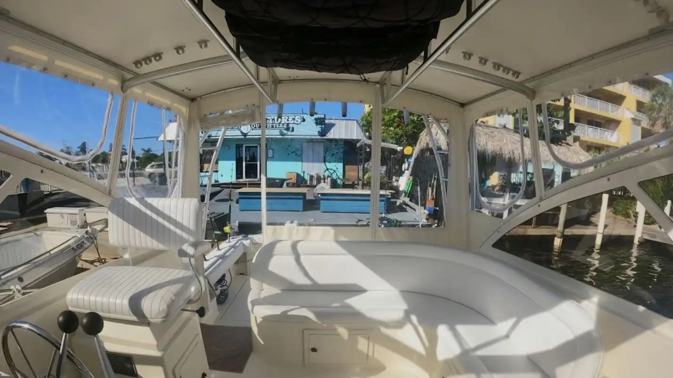Key West Sportfishing Boat Rental flybridge with wraparound seating and elevated helm station.