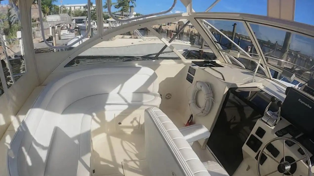 Key West Sportfishing Boat Rental helm with captain seating, navigation display and enclosed bridge area.