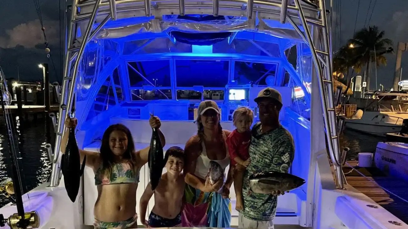 Key West Sportfishing Boat Rental with family displaying their catch after an offshore fishing adventure.