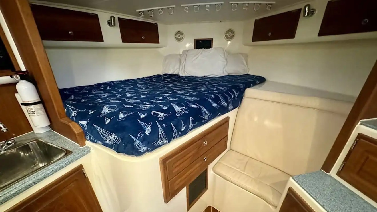 Key West Sportfishing Boat Rental cabin with private berth, lounge seating and compact galley.