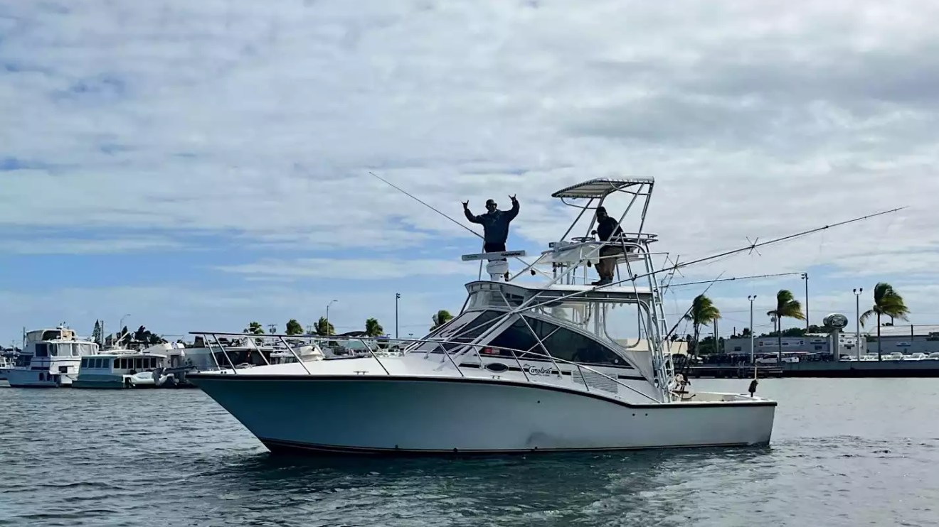 Sportfishing Boat Rental underway with tuna tower, outriggers and anglers aboard.