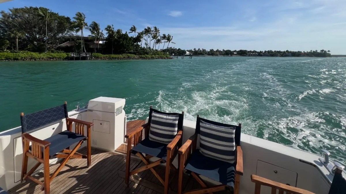 44' Uniesse Boat Rental with teak aft deck seating and waterfront views underway in Naples, Florida.