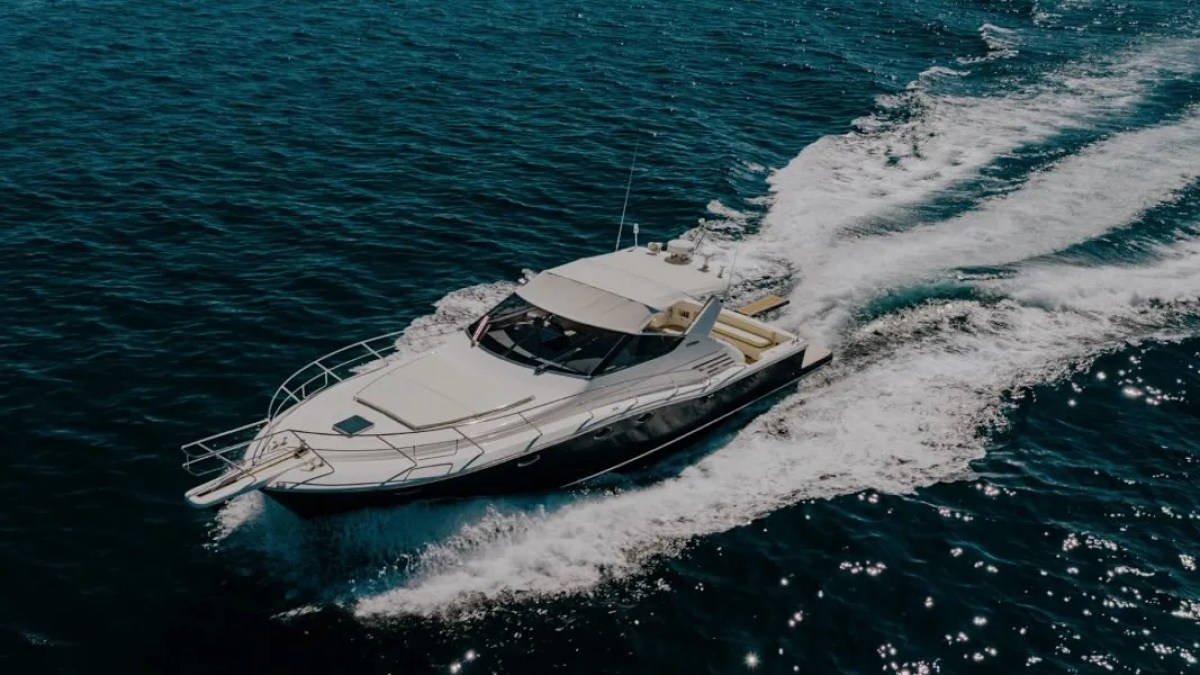 44' Uniesse Boat Rental underway with sleek express cruiser profile and open-water views in Naples, Florida.