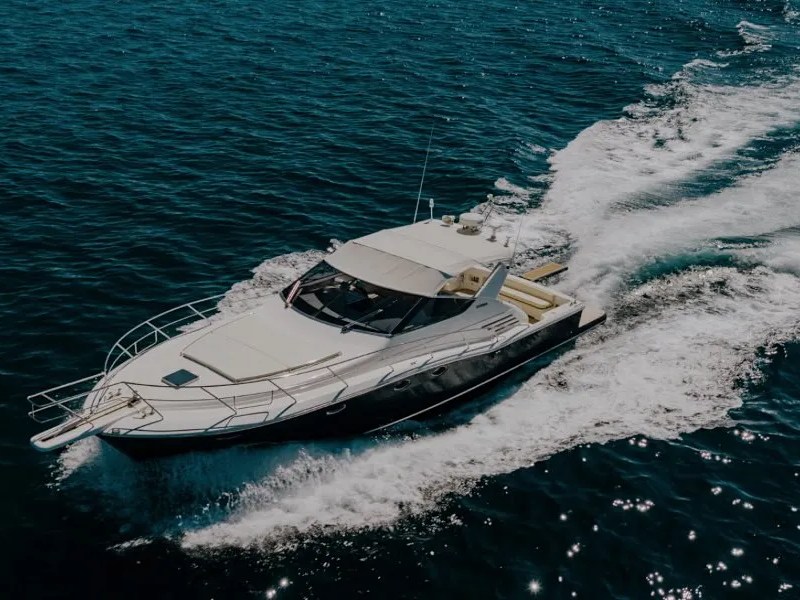 44' Uniesse Boat Rental underway with sleek express cruiser profile and open-water views in Naples, Florida.
