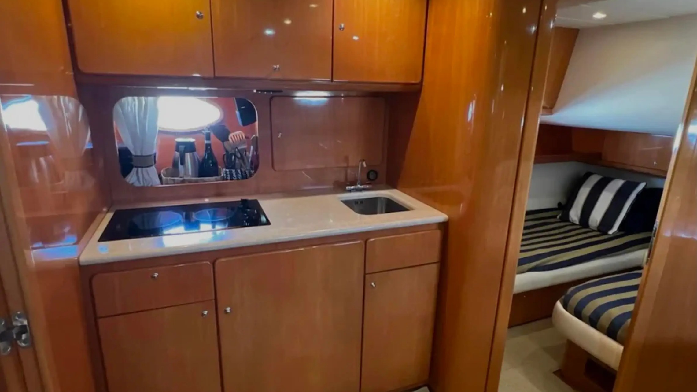44' Uniesse Boat Rental with private galley, wood cabinetry and sleeping cabin in Naples, Florida.