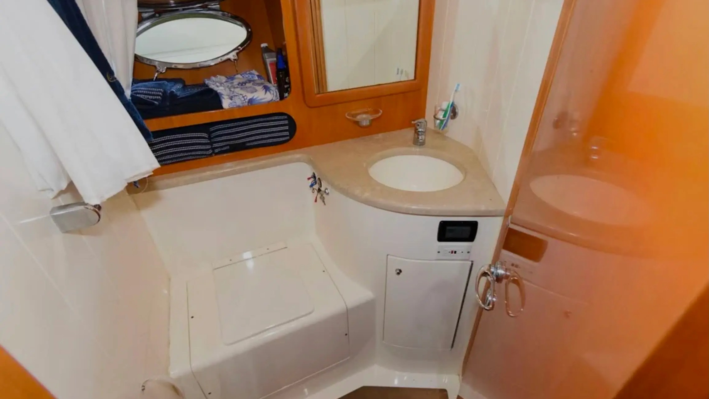 44' Uniesse Boat Rental with private bathroom, vanity and shower area in Naples, Florida.