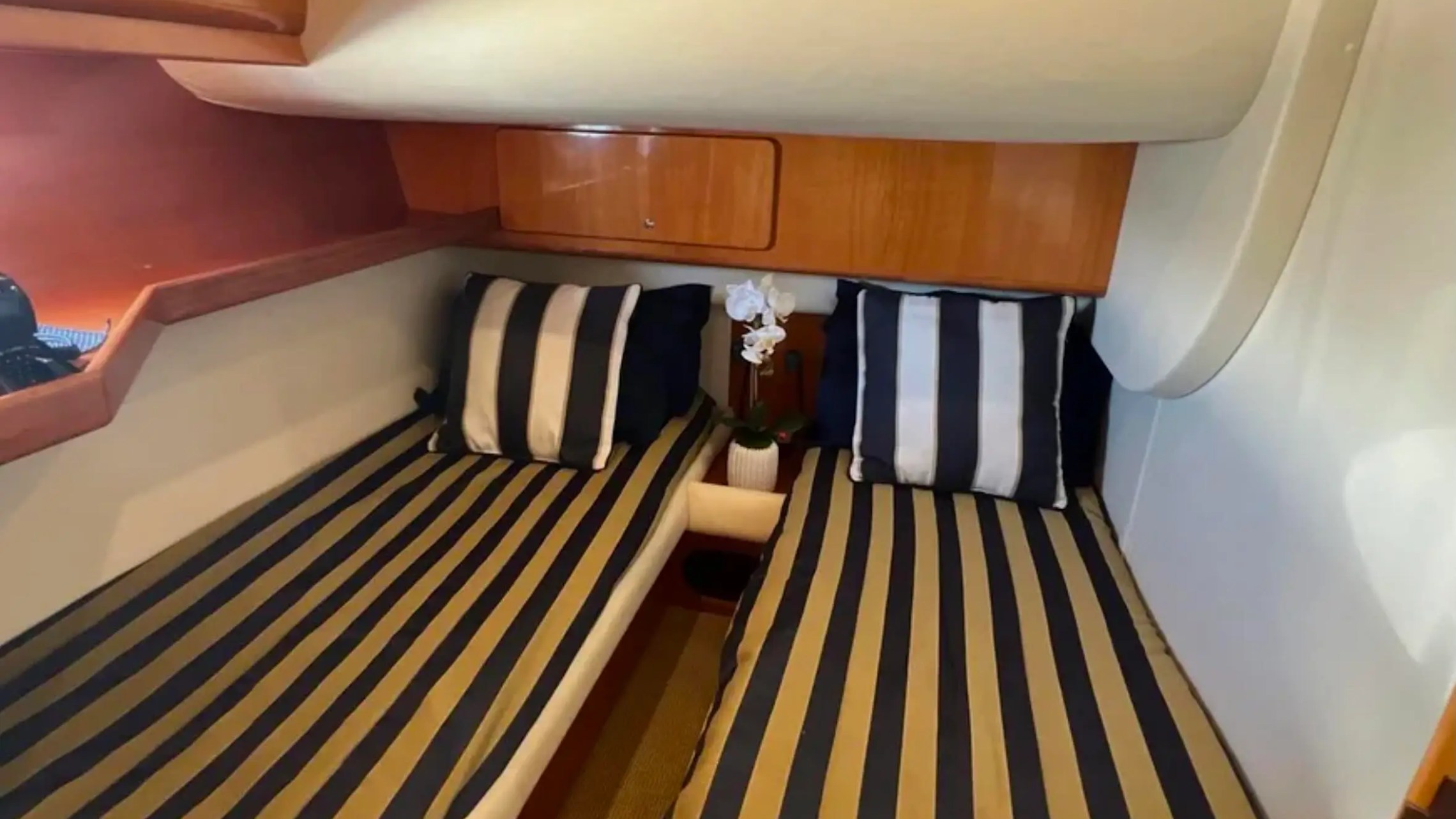 44' Uniesse Boat Rental with private twin berth cabin and polished wood cabinetry in Naples, Florida.