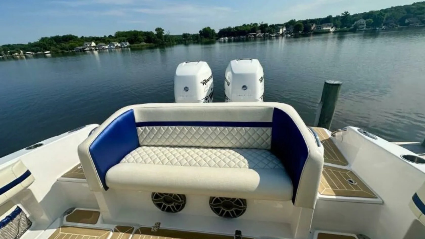Nor-Tech Boat Rental with diamond-stitched aft seating, twin outboards and spacious rear deck overlooking Florida waters.