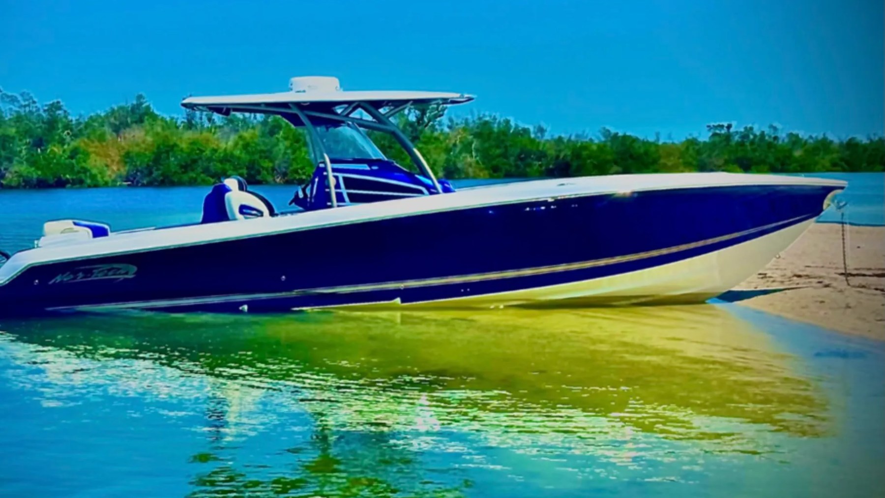 Nor-Tech Boat Rental with deep blue hull and hardtop anchored beside a secluded Florida sandbar.