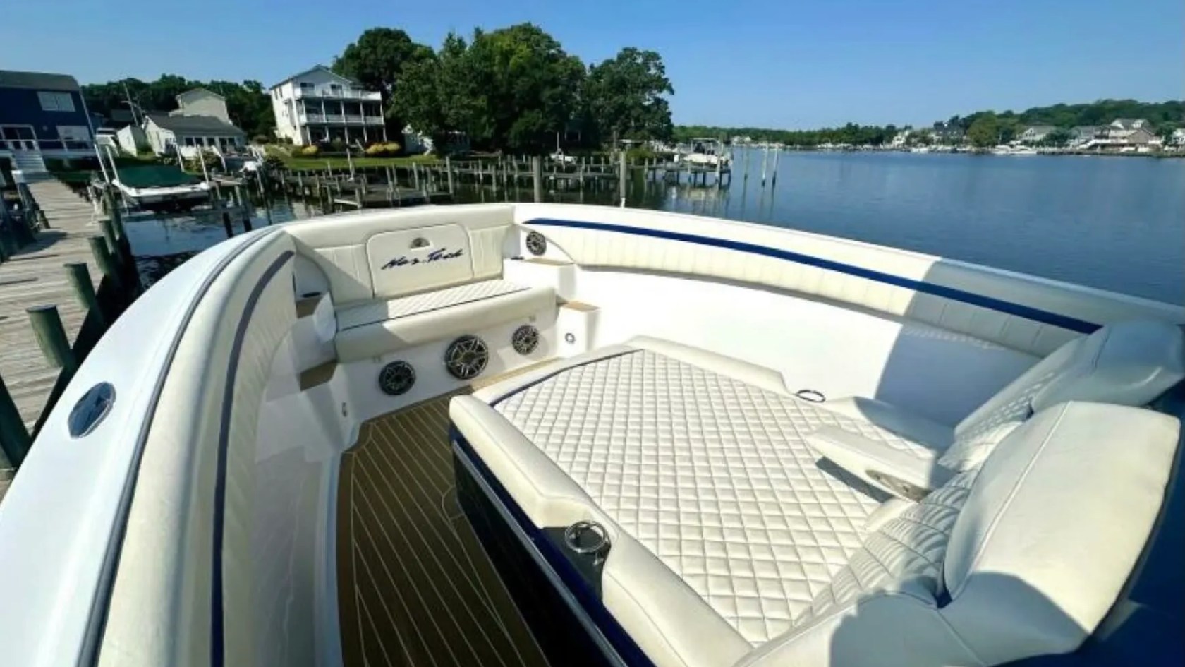 Nor-Tech Boat Rental with spacious bow lounge, wraparound seating and diamond-stitched sun pad overlooking Florida waters.