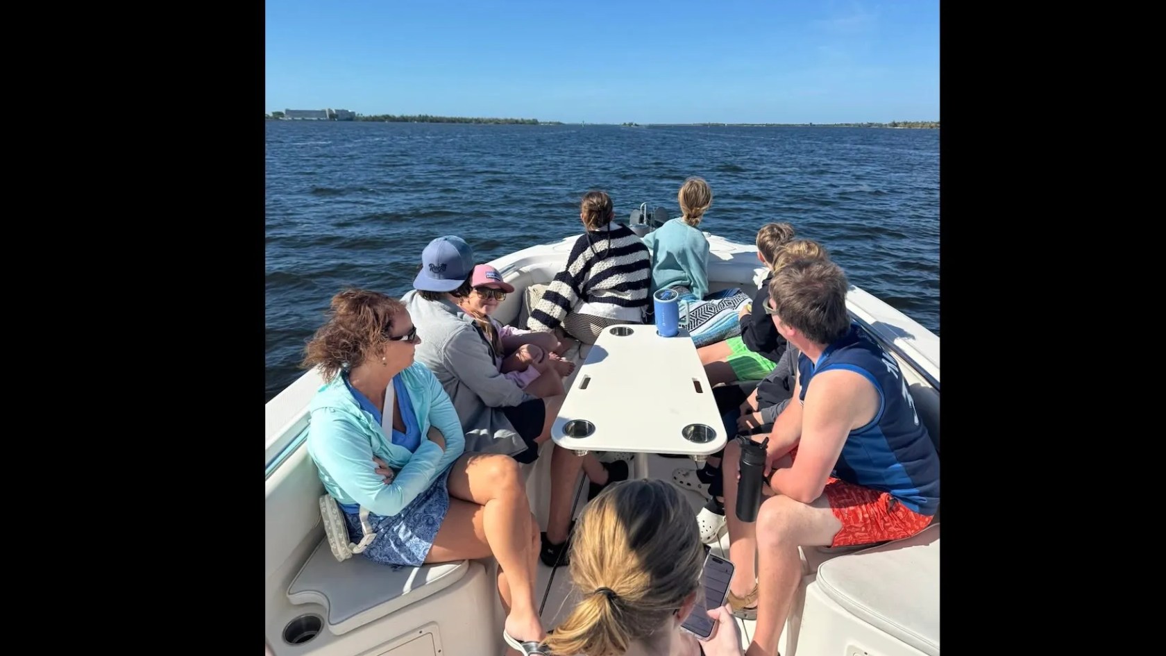 Scarab Boat Rental with family and friends relaxing in spacious bow seating while boating in South Florida.