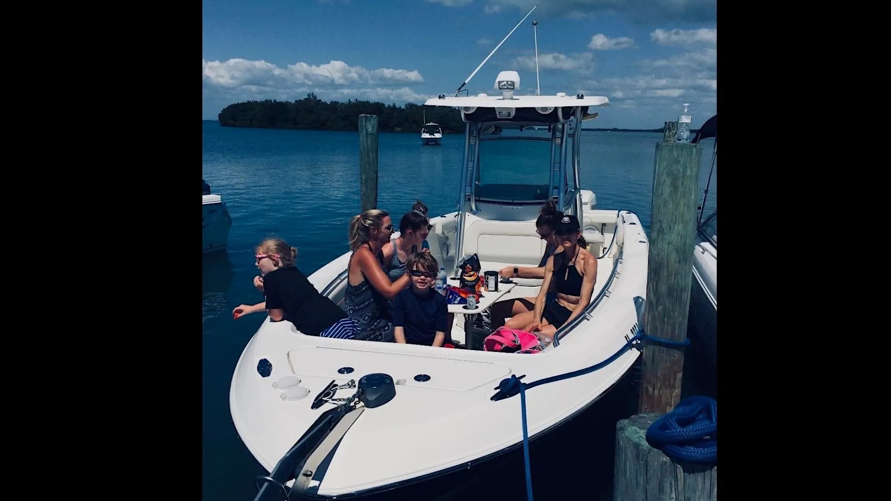 Scarab Boat Rental with family enjoying spacious bow seating and refreshments on South Florida waters.