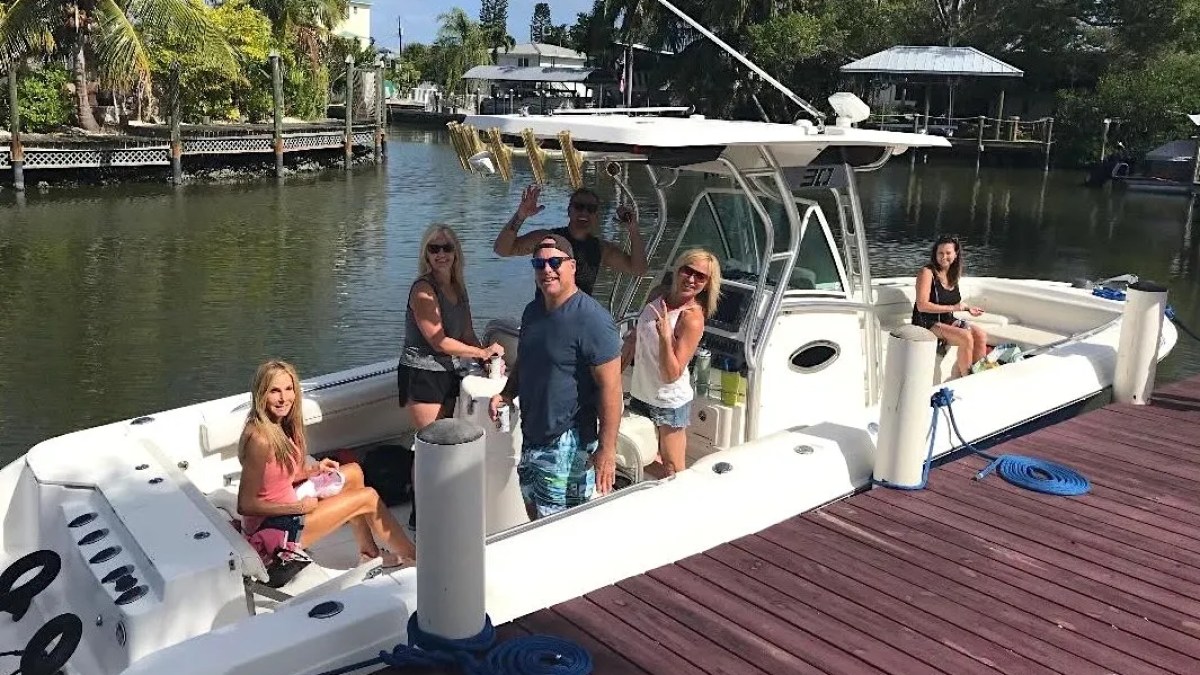 Scarab Boat Rental with guests aboard a spacious center console at a South Florida waterfront dock.