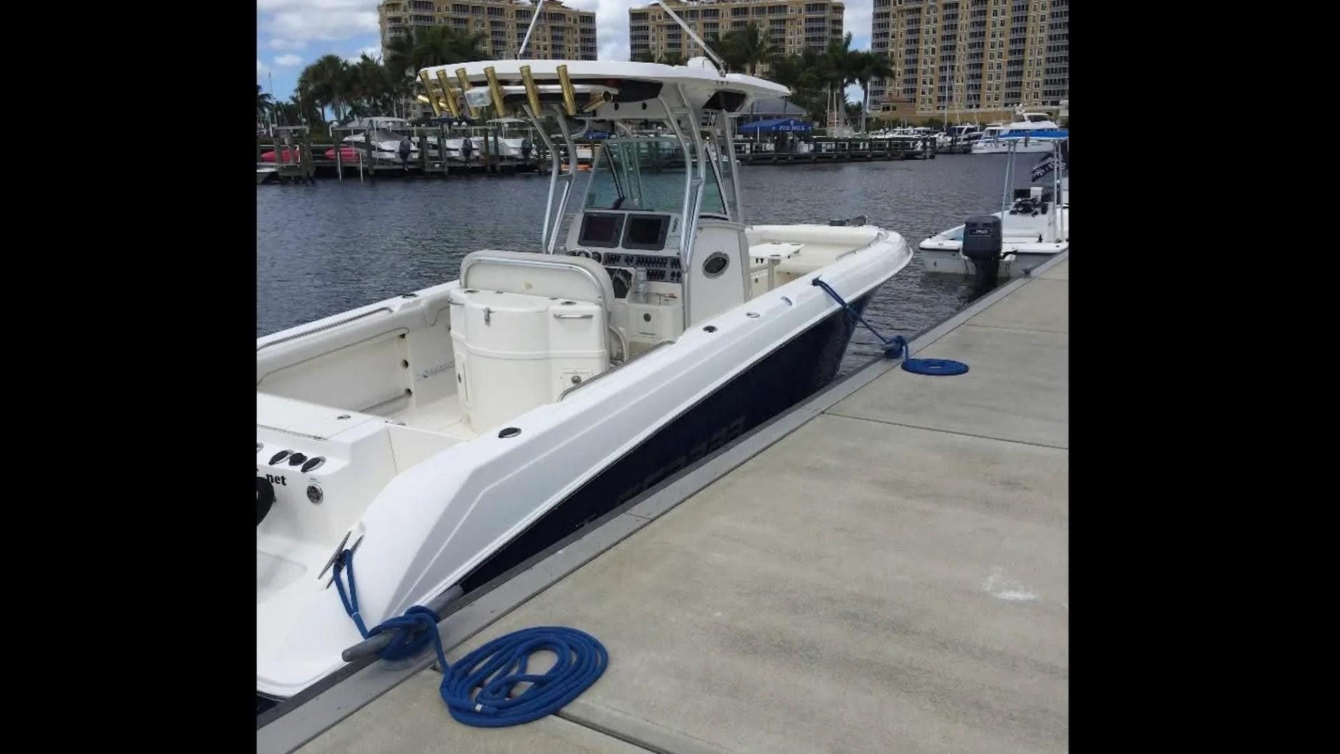 Scarab Boat Rental docked at a South Florida marina with spacious center console seating and hardtop.