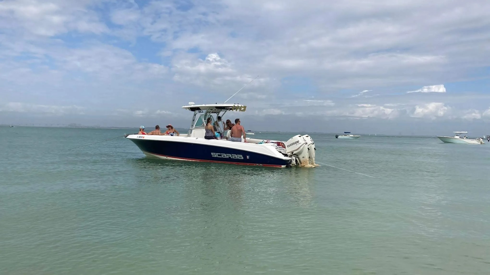 Scarab Boat Rental anchored in shallow tropical water with guests enjoying a South Florida sandbar outing.